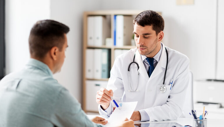 doctor showing prescription to patient at hospital